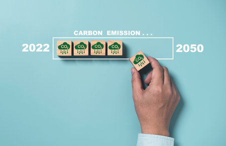 Man holding CO2 reducing icon with virtual loading for decrease CO2 , carbon footprint and carbon credit to limit global warming from climate change, Kyoto2050 protocol.の写真素材