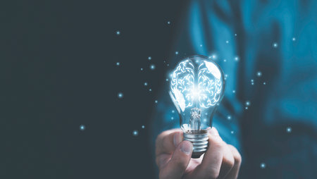 Businessman hand holding lightbulb with glowing virtual brain and  connection line to creative smart...