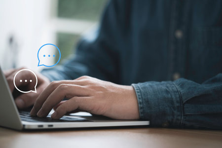 Businessman using computer laptop typing to send message to colleague , Communication by chat and social network technology concept.の写真素材