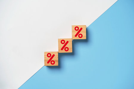Red percentage sign print screen on wooden cube block on white and blue background for increase...