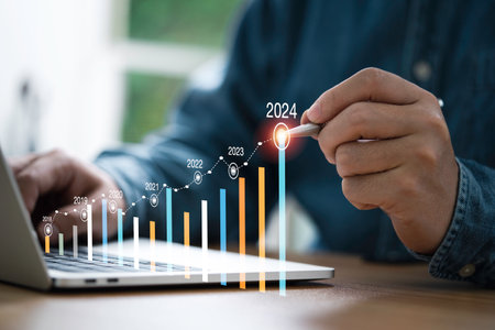 Businessman use electronic pen writing rising colorful graph from 2023 to 2024 year of business planing and stock investment growth concept.の写真素材