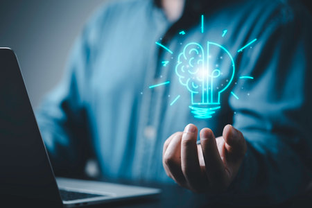 Businessman hand holding virtual glowing lightbulb to creative smart thinking idea for inspiration and innovation concept.の写真素材