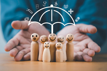 Businessman hand giving act with smile wooden figure and virtual umbrella for health insurance and assurance concept.の写真素材