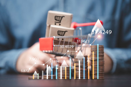 Increasing coins stacking with up arrow graph and shipping boxes inside of shopping trolley cart for economy inflation and grocery expensive price concept.の写真素材