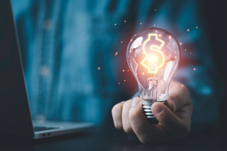 Businessman holding lightbulb and glowing dollar sign for creative thinking idea and problem solving can make more money concept.の写真素材