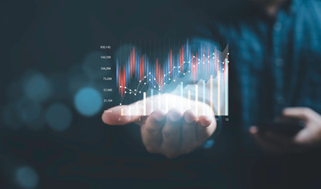 Businessman holding virtual technical graph and chart for analysis stock market, technology investment and value investment concept.の写真素材