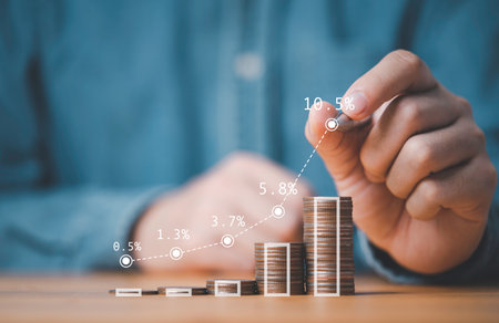 Businessman hand drawing virtual increasing graph with money coins stacking , Business investment profit and deposit dividend saving growth concept.の写真素材