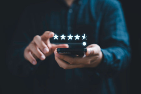 Businessman using mobile phone to give five stars for excellent evaluate after customer use product...