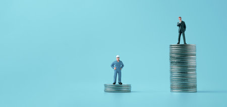Different miniature businessman standing on different height coins stacking , Inequality income and salary in each position in company concept.の写真素材