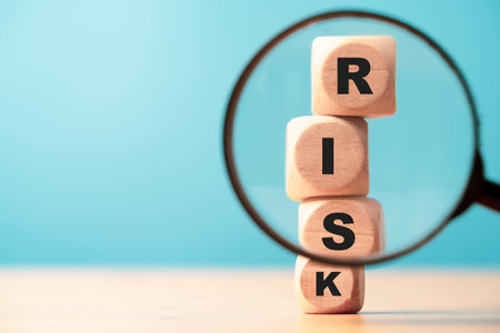 Risk wording print screen on wooden block cube and focus on magnifier glass for financial banking risk analysis and management ,Risk and return concept.の写真素材