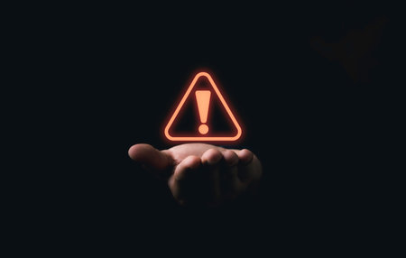 Red triangle caution warning sign on hand for maintenance notification error and risk concept.の写真素材