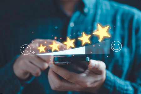 Businessman use smartphone to give five glowing golden stars for excellent evaluation survey after client use product and service from customer satisfaction concept.の写真素材