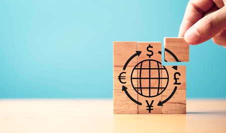 Hand assemble central banking and international currency include dollar Yuan Yen Pound sterling and Euro which print screen on back cube for forex and currency exchange money transfer concept.の写真素材