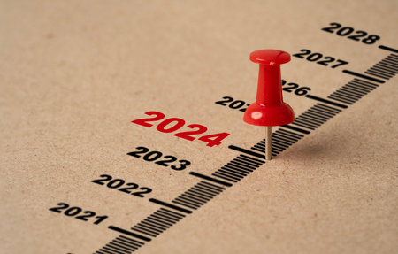 Red pin on paper with 2024 year for preparation merry Christmas and happy new year concept.