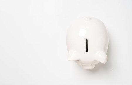 Top view of white piggy bank with copy space for money saving to investment and profit concept.の写真素材