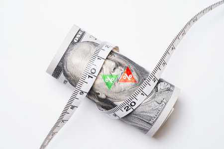 USD dollar banknote with green up arrow and red down arrow percentage was wrapped by a tape measure for united states of America's public debt is high and the debt ceiling needs to be raised concept.の写真素材