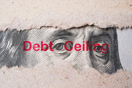 Benjamin Franklin face from USD dollar banknote behind of torn paper with debt wording for America's...