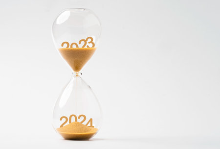 Sand inside of hourglass of change year from 2023 to 2024 for countdown of merry Christmas
and happy new year concept.の写真素材
