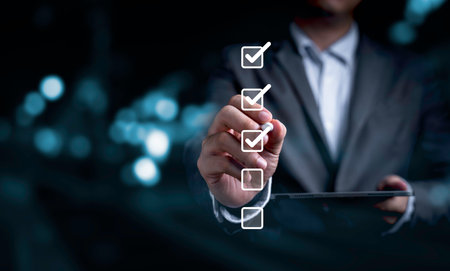 Businessman use pen to tick correct sign mark in checkbox for quality document control checklist and business approve project concept.の写真素材