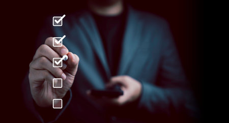 Businessman use pen to tick correct sign mark in checkbox for quality document control checklist and business approve project concept.の写真素材