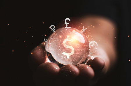 Hand holding crystal world on banknote with international currency sign include dollar Yen Yuan Euro Pound sterling Ruble Rupee for money transfer and forex exchange concept.の写真素材