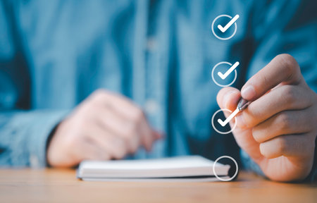 Businessman use pen to tick correct sign mark in checkbox for quality document control checklist and...