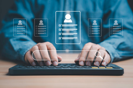 Headhunter using computer to check and select the optimum resume application form , Human development and recruitment to interview and join with company concept.の写真素材