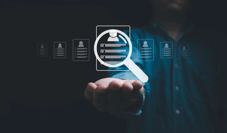 Headhunter hand holding and select the optimum resume application form , Human development and recruitment to interview and join with company concept.の写真素材