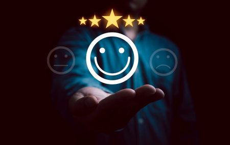Businessman hand give smile face with glowing yellow five stars for client the best satisfaction evaluation survey after use product and service concept.の写真素材