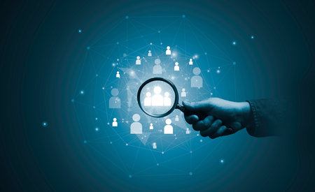 Hand holding magnifier glass with human icon for focus customer target of customer relation management or CRM and human development concept.の写真素材