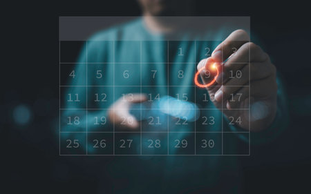 Businessman using pen to writing circle mark on virtual calendar agenda of booking and appointment...