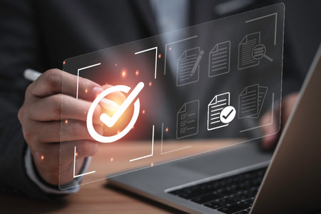 Businessman using laptop computer with correct sign mark and document icon for ISO or International Standard Organisation which related quality control and continuous improvement concept.の写真素材