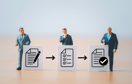 Miniature figure businessmen standing with white paper and document icon for prepare , check and approve document and project concept.の写真素材