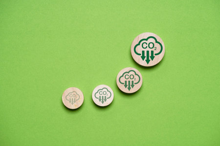 Bigger of CO2 reducing icon on green background for decrease CO2 emission, carbon footprint and carbon credit to limit global warming from climate change,Circular Green Economy within 2050 concept.の写真素材
