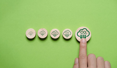 Hand touching bigger of CO2 reducing icon for decrease CO2 emission, carbon footprint and carbon credit to limit global warming from climate change,Circular Green Economy within 2050 concept.の写真素材