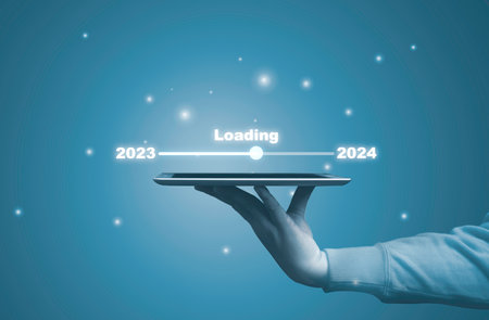 Hand holding tablet with infographic downloading from 2023 to 2024 for countdown merry Christmas and happy new year concept.の写真素材