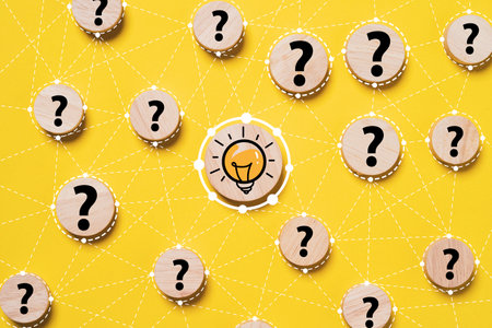 Glowing lightbulb connection linkage with question mark on round wooden for creative thinking idea innovation and problem solving solution concept.の写真素材