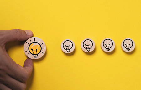 Hand holding glowing lightbulb move out from lamp icon  for creative thinking idea innovation and problem solving solution concept.の写真素材