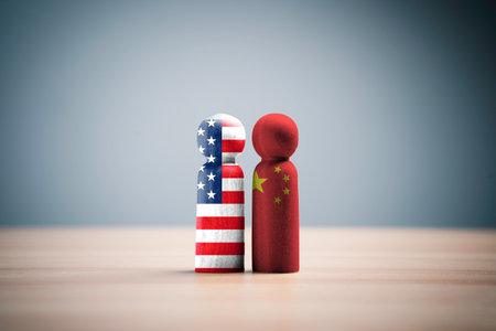 USA and China flags print screen on wooden figure for competition between both countries include tariff trade war , military war and technology  war concept.の写真素材