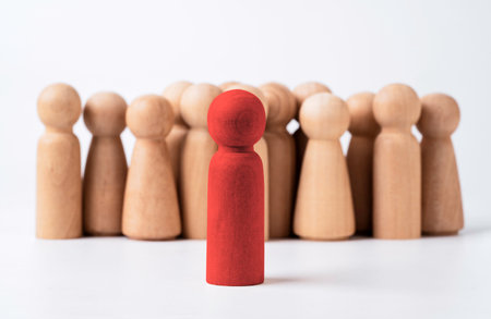 Red brave wooden figure stand in front of crowd normal figure for leadership and management concept.の写真素材