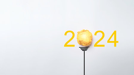 Yellow scrap paper ball for virtual lightbulb with 2024 on white background for creative thinking...