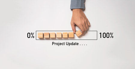 Hand arrange wooden block cube download bar from 0% to 100% for project update progress concept.の写真素材