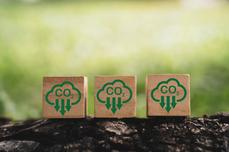 CO2 reducing icon on wooden block cube for decrease CO2 , carbon footprint and carbon credit to...