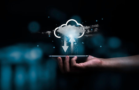 Hand holding smartphone with virtual cloud computing technology for uploading and downloading information data concept.の写真素材