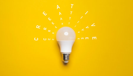 White lightbulb with on yellow background for creative thinking idea for patent and problem solving...