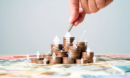Hand putting coin to heap of coins money with up arrow and percentage symbol for financial banking...