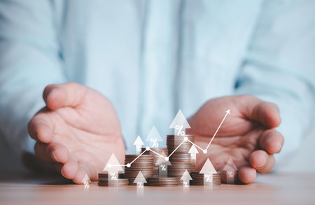 Two hand giving heap of coins money with up arrow and percentage symbol for financial banking increase interest rate or mortgage investment dividend from business growth concept.の写真素材