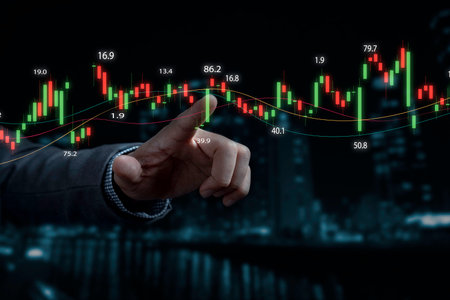 Businessman hand touching to stock market graph chart with skyscraper background for investor analysis stock and forex trading concept.の写真素材