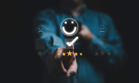 Businessman touching to five golden stars with smile face icon for client the best experience after use product and get service , customer feedback evaluation and satisfaction concept.の写真素材