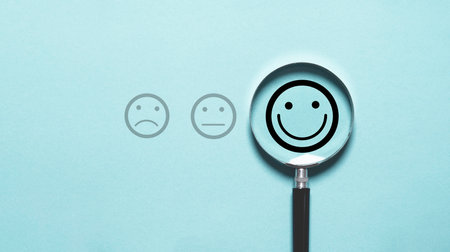Smile face icon inside magnifier glass for customer excellent evaluation and feedback survey after use product and service concept.の写真素材